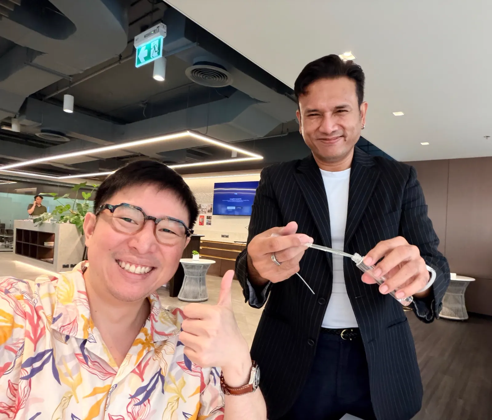 Two collaborators smiling during an office session