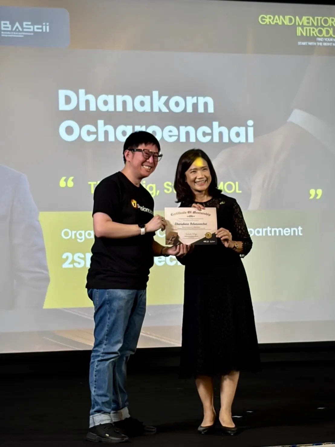 smolteam member receiving a certificate of mentorship on stage