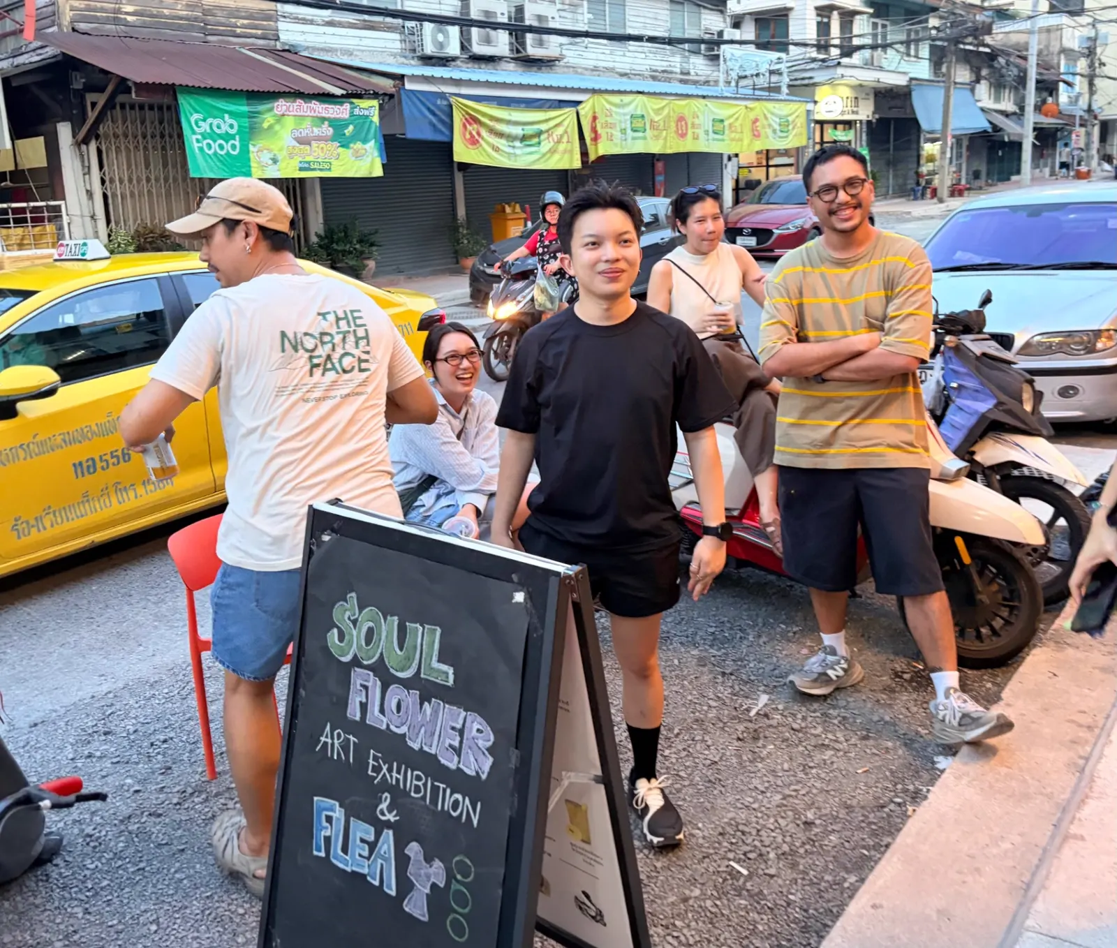 Friends gathered outside a street art exhibition and flea market